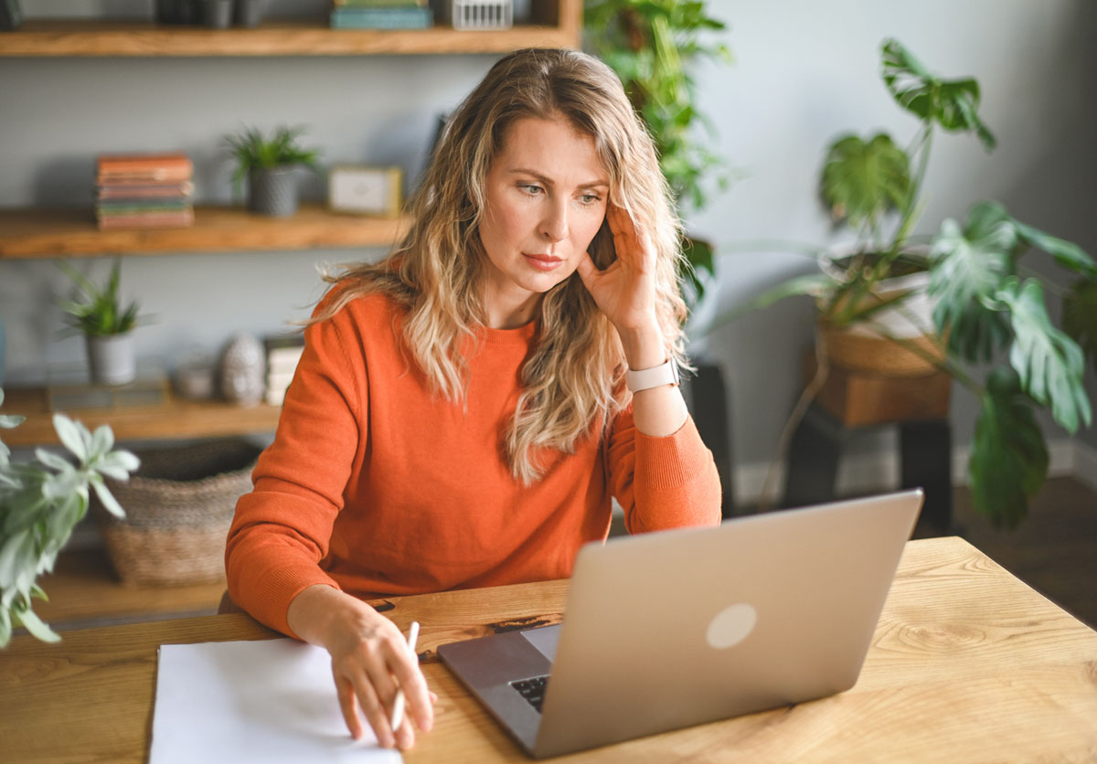 stressed woman working at home on laptop
